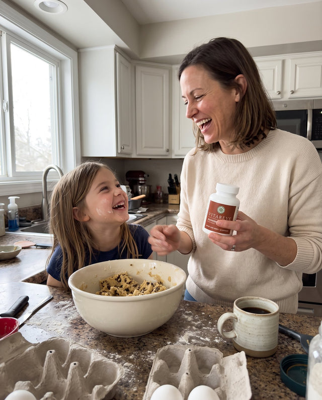 Emily, 42, baking with her daughter, holding a bottle of Vitareve Mushroom Complex 10X